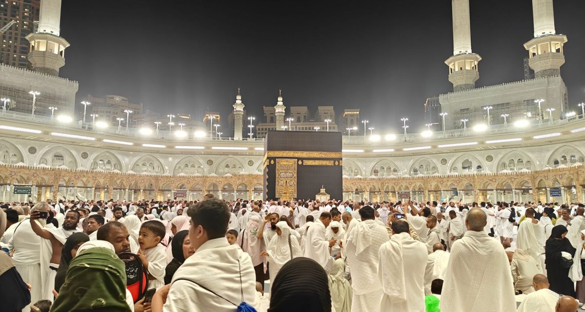 Night view of pilgrims gathered around the Kaaba in Mecca, Saudi Arabia during Hajj.