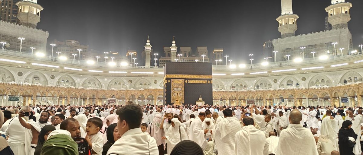 Night view of pilgrims gathered around the Kaaba in Mecca, Saudi Arabia during Hajj.
